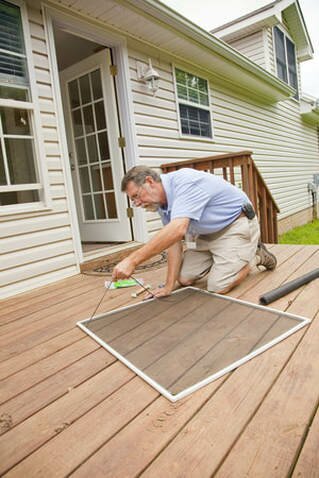 handyman fixing window screen