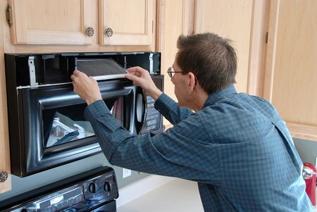 handyman repairing appliances